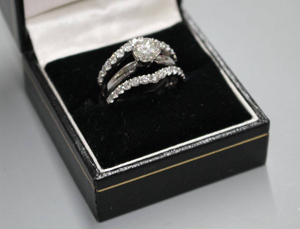 A modern 14kt white metal and triple band diamond dress ring,